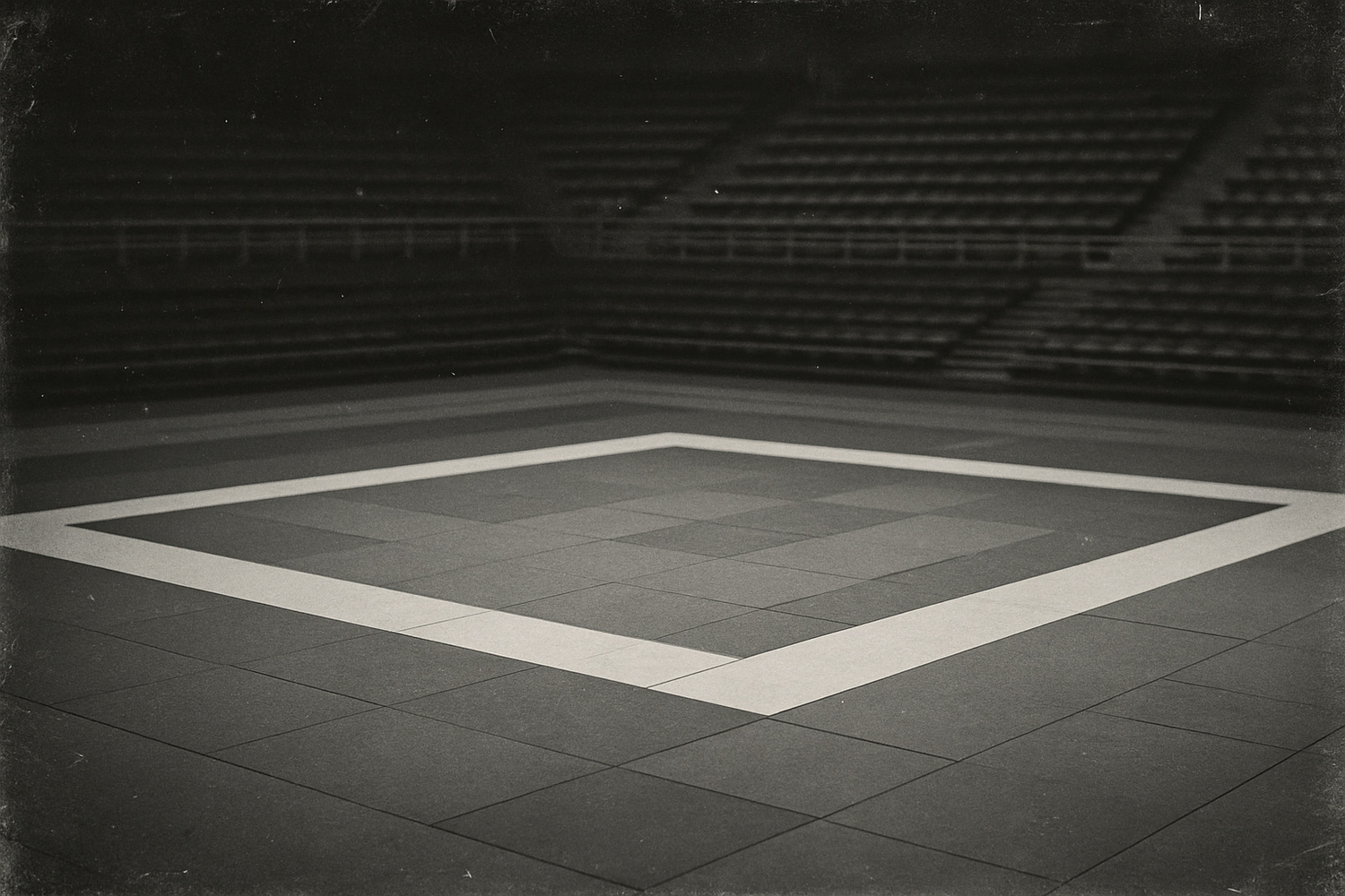 An empty black and white judo tournament ring. The photo quality should have artifacts as if it were a vintage photo.